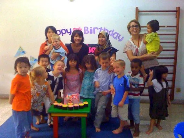Treen and her students in Indonesia, celebrating a birthday.