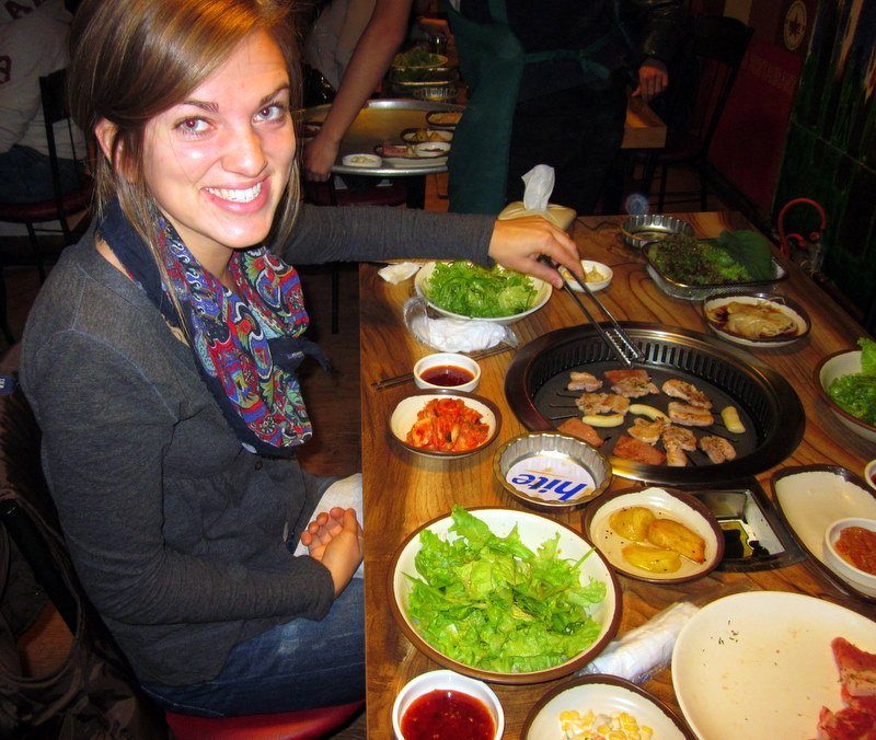 Natalie with delicious South Korean food.