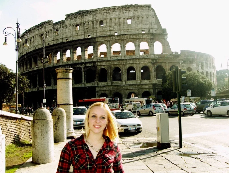Kelly in Rome in 2010, sun glowing through the Colosseum.