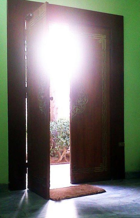 Sun shines through a door in Cairo.