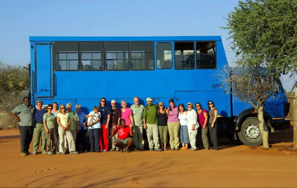 Peggy's GEEO group, travel truck, and Zimbabwean guides.