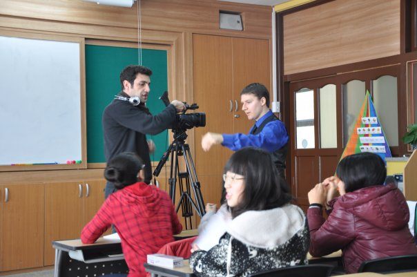 Murat and Steventeacher set up for a shot in South Korea while the students get ready for another take.