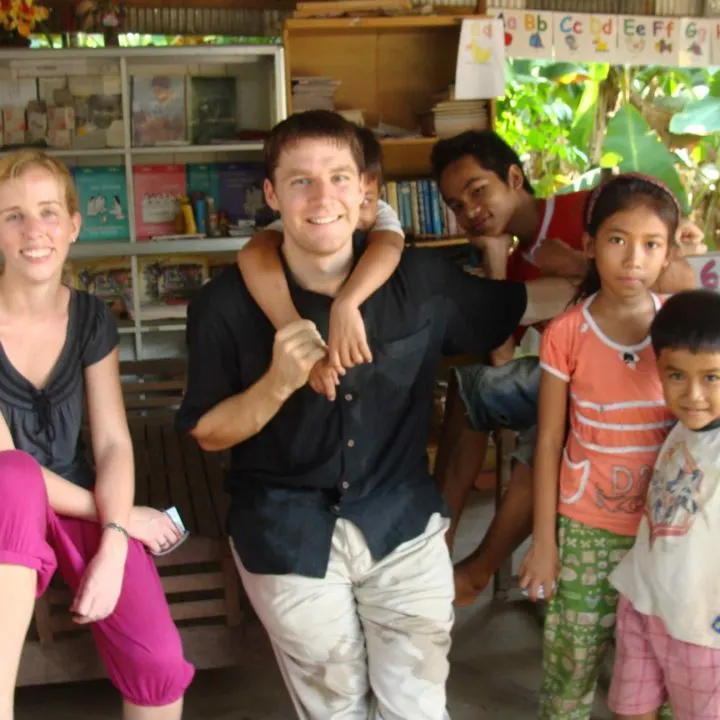 Emily and Steventeacher with kids in Cambodia.