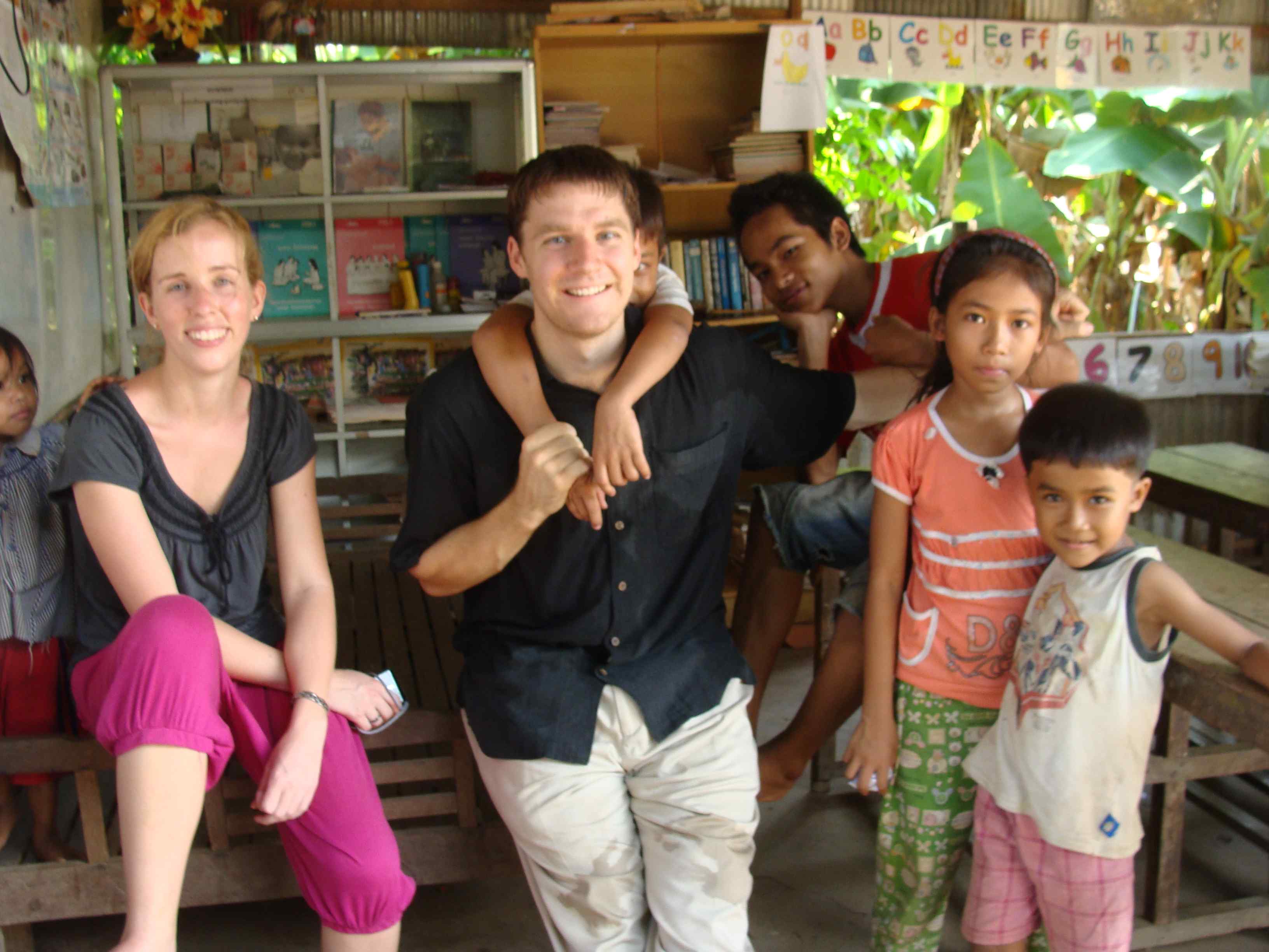 Emily and Steventeacher with kids in Cambodia. 