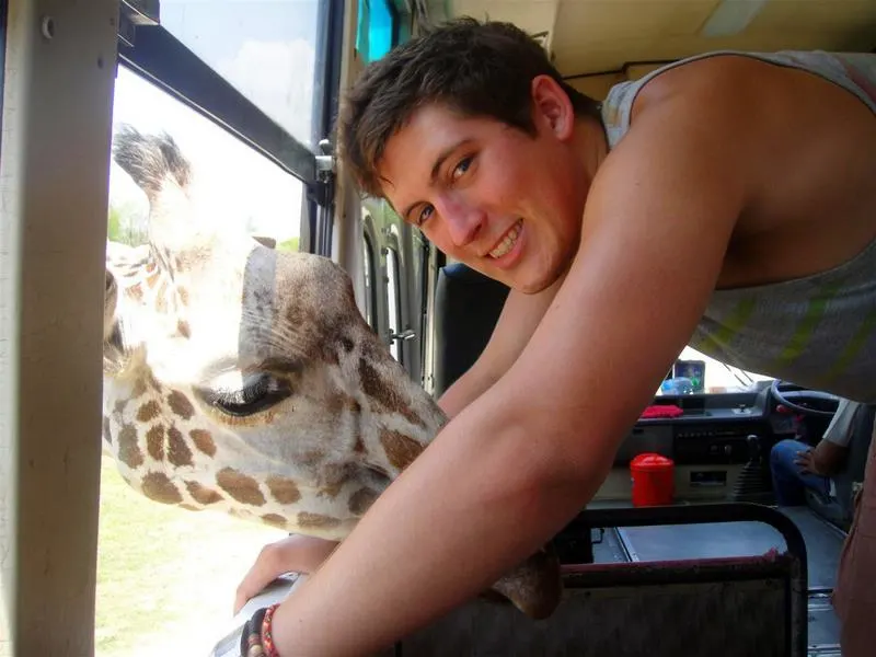 Mike with a giraffe at the Zoo at Kanchanaburi, Thailand.