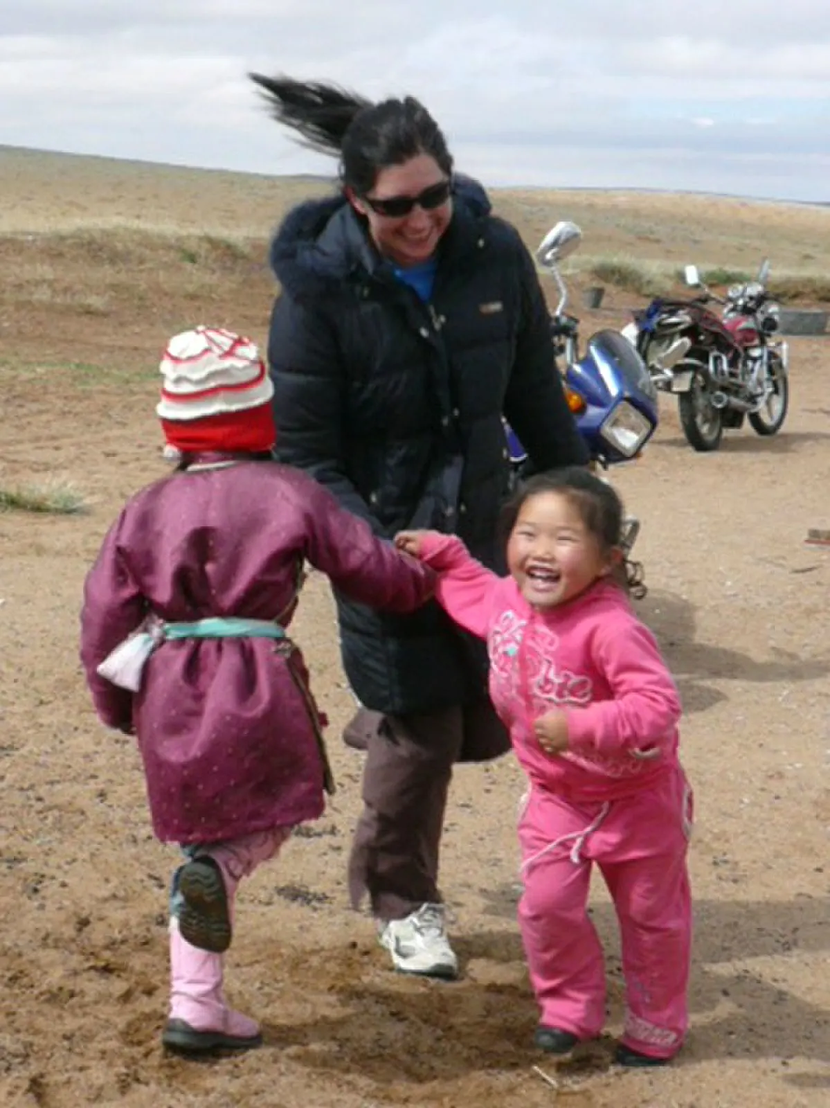 Lisa playing with happy kids in Mongolia.