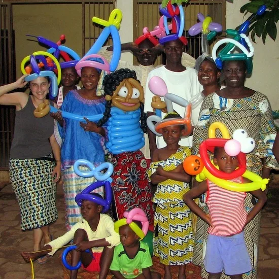 Sara with her balloon animal creations and host family in Mali!
