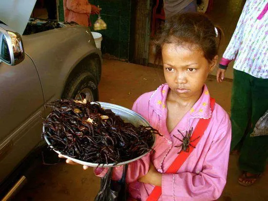 Girl selling tarantulas in Cambodia. Oh my!