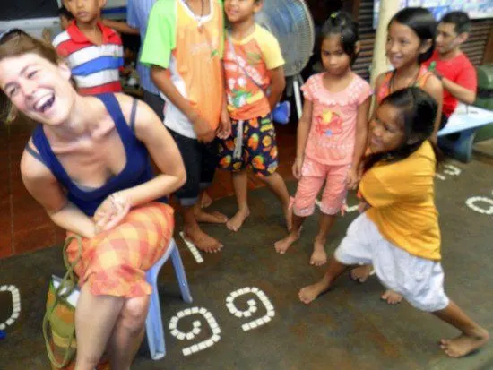 Charlie having fun with kids while volunteering in Goa.