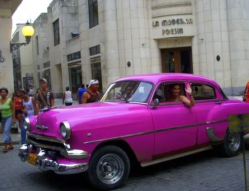 Sarah in an old-fashioned car during Cuba travel!