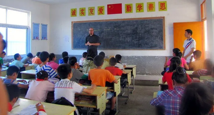 Chris in the classroom during his time teaching abroad in China, while not getting punched in the face.