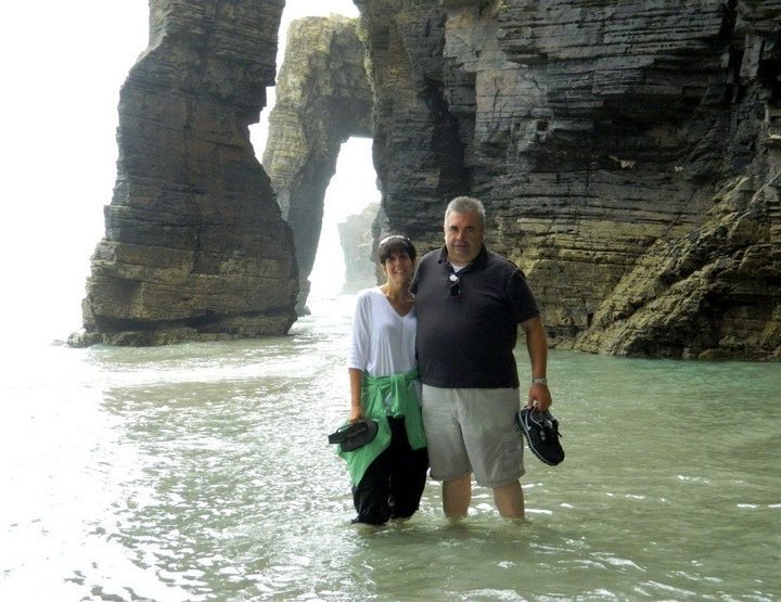 Kelly and her husband at Playa de las Catedrales in the Rias Altas of Galicia, Spain. These rock formations are hidden underwater at high tide. This beach, named a national monument, was named Europe's most beautiful beach.