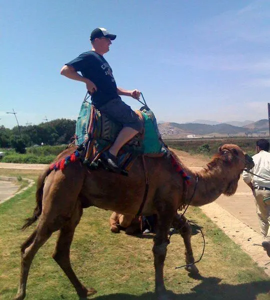 Mike riding a camel in Morocco.