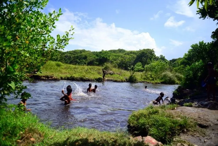 Children Swimming in a Waterhole in the Dominican Republic. 