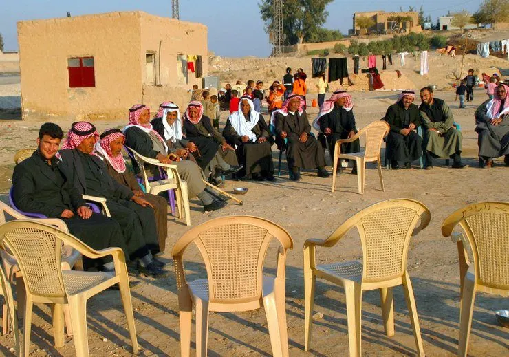 The men sit separately from the women at this family gathering during Holy Week in eastern Syria.