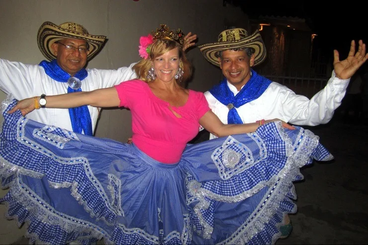Kate wearing a traditional falda, dancing in Barranquilla, Colombia, February 2014 with two members of Guapachosa, a Cumbia group during the weekend of Guacherna, just before Carnaval begins.