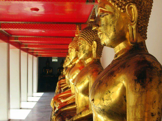 Rows of gold Buddhas at Wat Pho in Bangkok. 