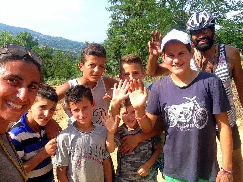 Andrea (left) in Albania, saved by a group of children who gave her water during a mountain hike.