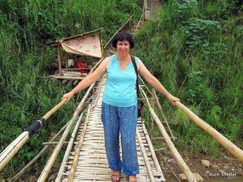 Ruth on a rope bridge in Laos during her travels.
