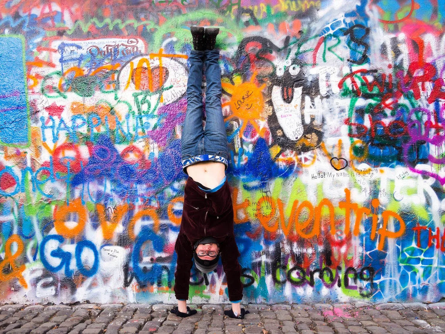 Handstand in front of a famous graffiti wall in Prague. 