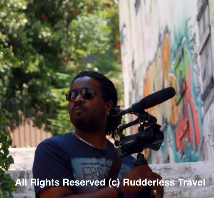 Christopher filming the streets of Athens, Greece for the Rudderless travel vlog.