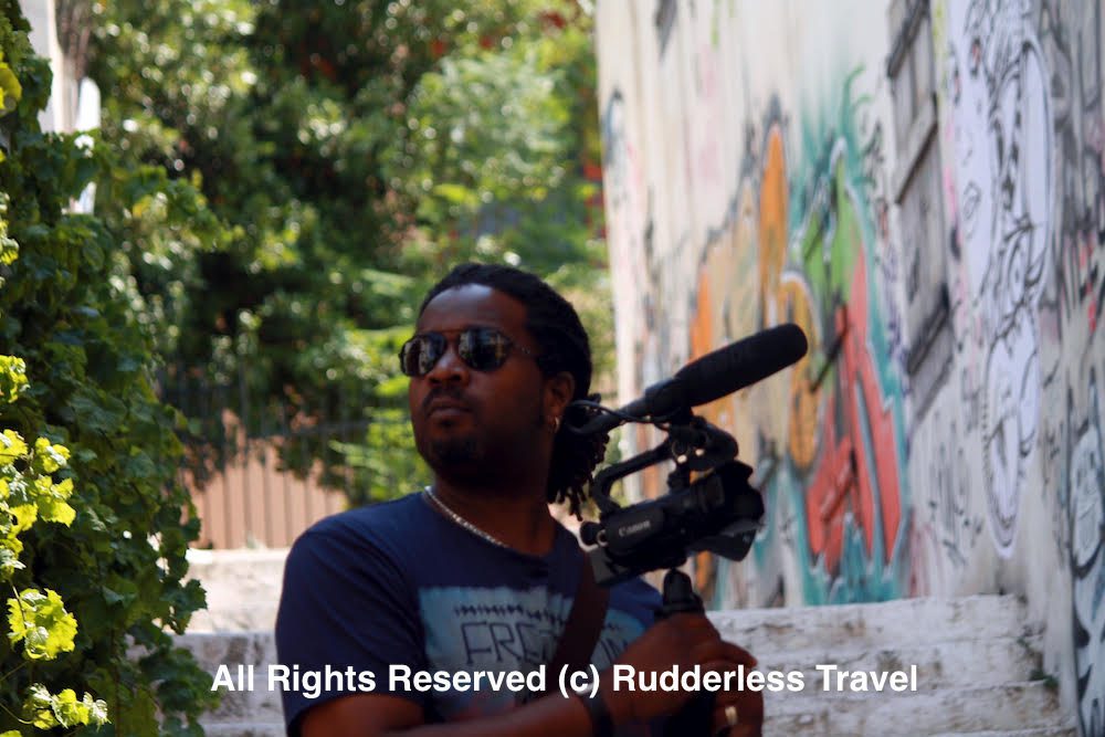 Christopher filming the streets of Athens, Greece for the Rudderless travel vlog.