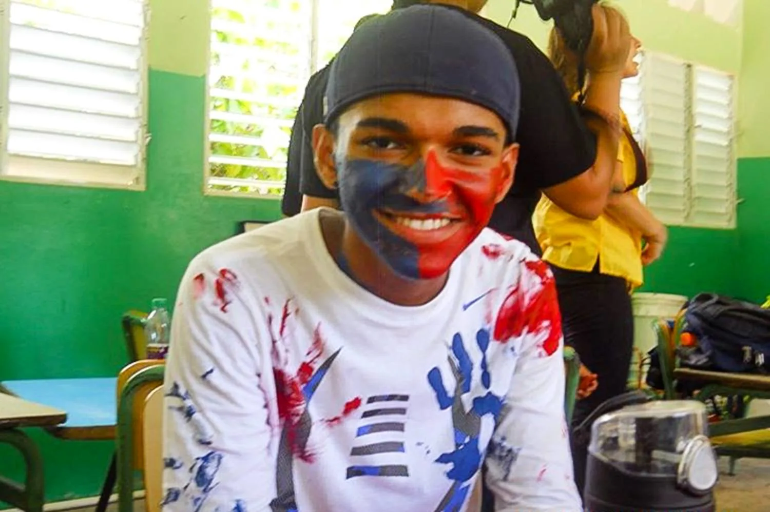 Irvin, covered in paint from the volunteer project!