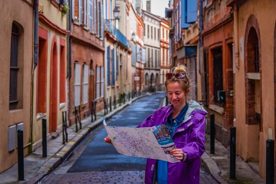 Using a map to find her way around Toulouse, France.