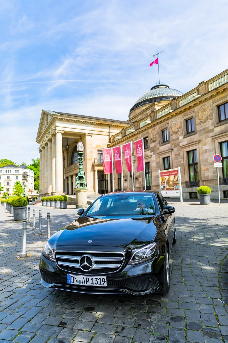 Why taking a road trip can be the best way to learn while traveling, as explained by travel blogger JQ Louise, who roadtripped through Germany's Frankfurt-Rhine-Main region. This European gem is full of food, castles and sight seeing, and JQ learned about Germany like a local. Pictured: The rental car at the Kurhaus in Wiesbaden.