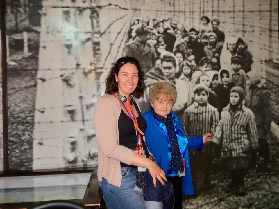 With Eva Kor in front of a liberation photo. The child she is pointing to is herself! The little girl next to her was her twin sister, Miriam. 