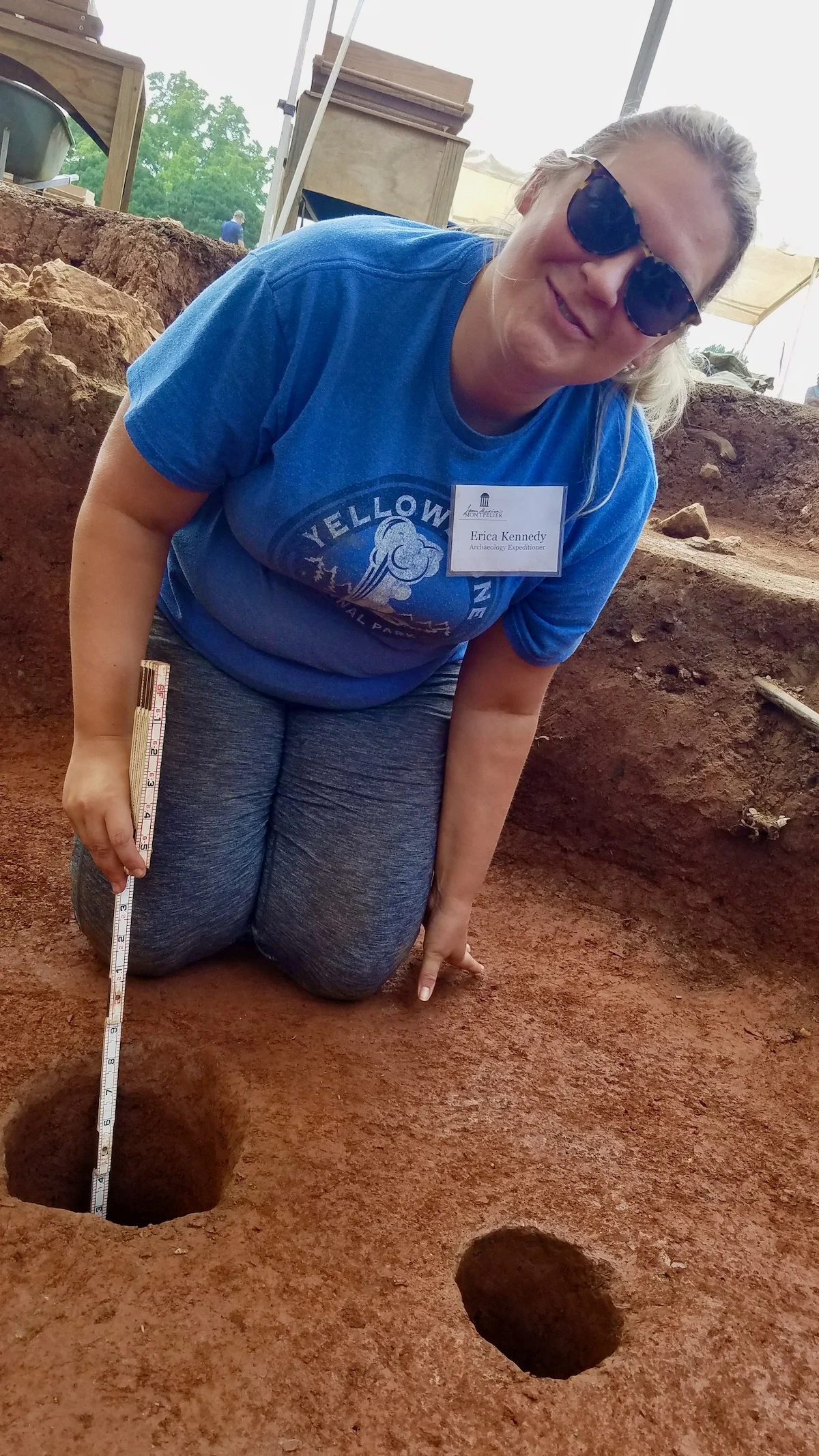 Measuring a feature. (A feature is an artifact that can't be brought back to the lab to interpret.) This is where one of the original trees were planted. A new silver pine will be planted soon to show what this part of the plantation looked like during James Madison's time.