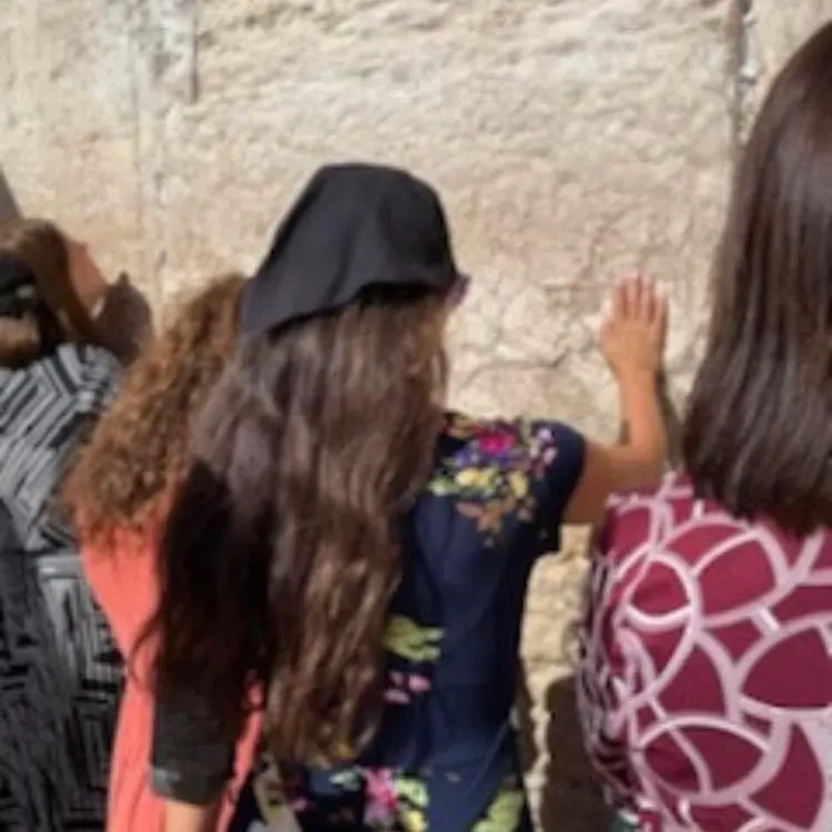 Touching the Western Wall in Jerusalem.