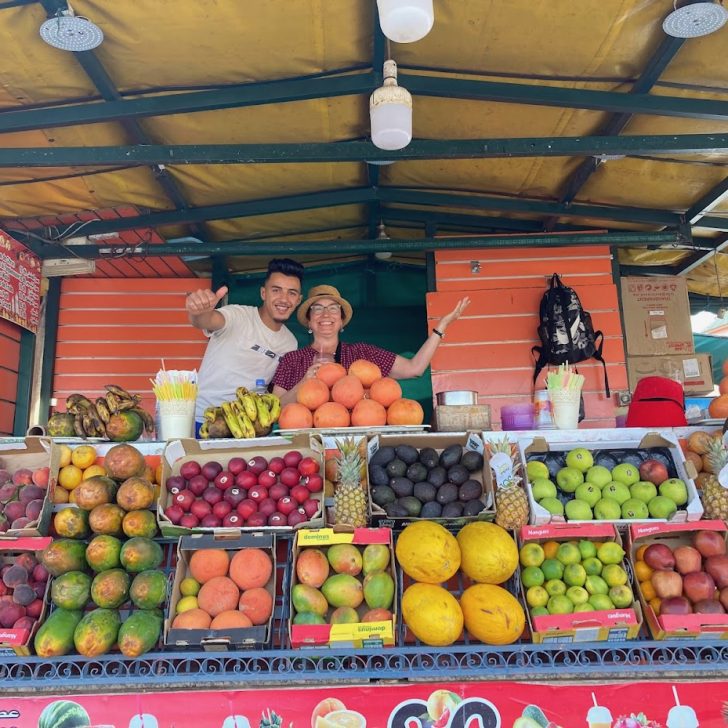 Posing with fruit sellers in Morocco.